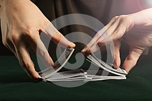 Young boy Shuffling a Deck of playing Cards