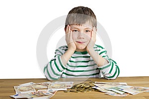 Young boy is sitting in front of money