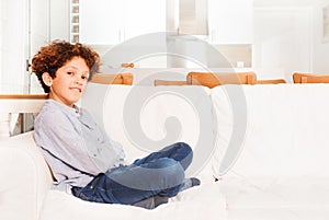 Young boy sitting on sofa in the lounge room