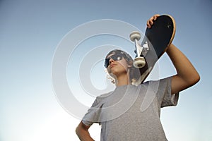 Young boy with skateboard in hand