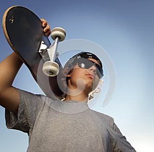 Young boy with skateboard in hand