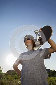 Young boy with skateboard in hand