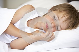 Young Boy Sleeping In Bed