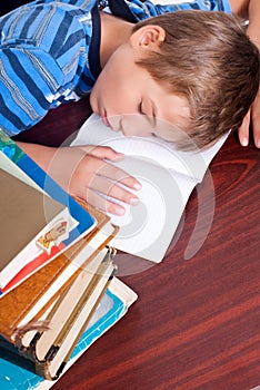 Young boy sleeping on his desk