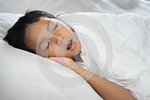 Young boy sleeping with mouth open snoring