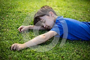 Young boy sleeping in park