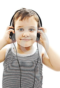 The young boy is smiling and listening to music