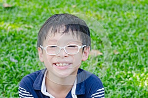 Young boy smiling in park