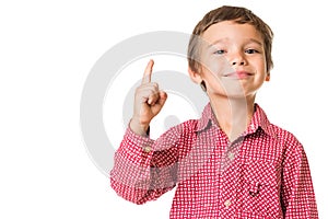 Young boy smiling and pointing finger upwards