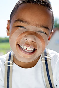 Young boy smiling with suspenders