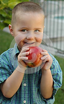 Young boy snacking on a juicy