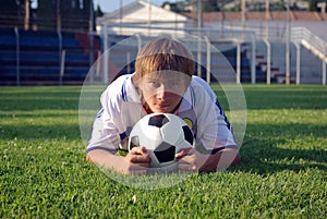 A young boy with a soccer ball