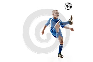 Young boy with soccer ball doing flying kick