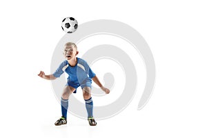 Young boy with soccer ball doing flying kick