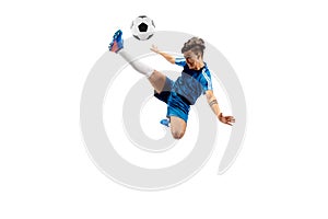 Young boy with soccer ball doing flying kick