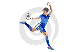 Young boy with soccer ball doing flying kick