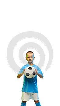 Young boy with soccer ball isolated on white studio background, vertical flyer with copyspace