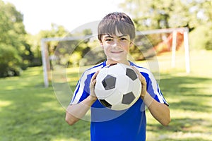 Young boy with soccer ball on a sport uniform