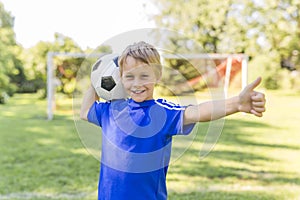 Young boy with soccer ball on a sport uniform