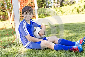 Young boy with soccer ball on a sport uniform