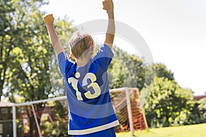 Young boy with soccer ball on a sport uniform