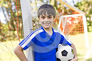 Young boy with soccer ball on a sport uniform