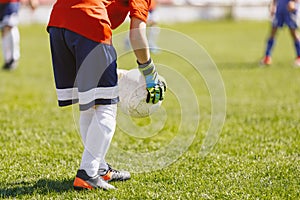 Young Boy Soccer Football Goalkeeper Holding Ball in Hand Gloves