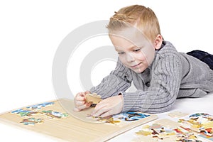 Young boy solving a puzzle