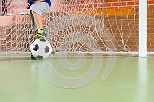 Young boy standing in the soccer goal