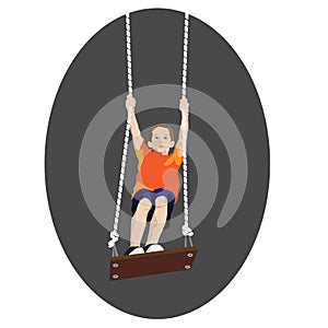 Young boy standing on a tree swing