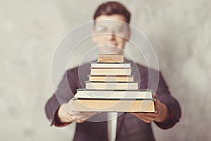 Young boy student with books in glasses. happy guy want learning, have education. online education. Study in school. Male blur.