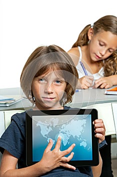 Young boy student showing world map on tablet.