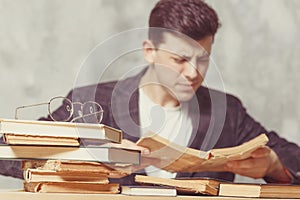 Young boy student sitting near the table with books. blind guy want learning, have education. online education. Study in school.