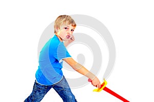 Young boy in studio playing with sword on white background