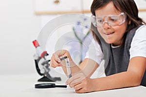 Young boy study plant in biology class