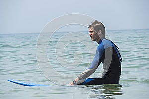 Young boy surfing in the sea, waiting waves