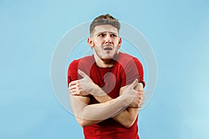 Young boy with a surprised expression bet slip on blue background