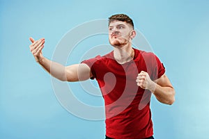 Young boy with a surprised expression bet slip on blue background