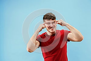 Young boy with a surprised expression bet slip on blue background