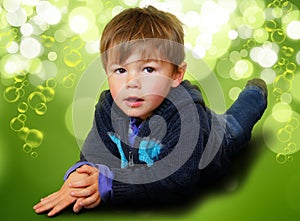 Young boy surrounded in bubbles & bokeh