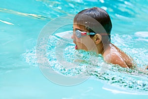 Young boy swimming.