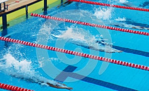 Young boy swimming Freestyle posture in the blue water pool.