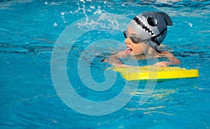 A young boy in swimming pool