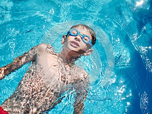 Young boy swimming on a swimming pool. close up look