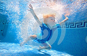 Young boy swimming underwater