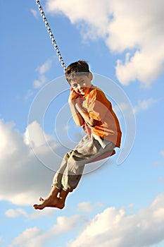 Young boy on swing