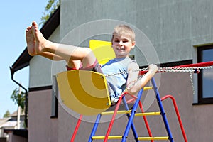 Young boy on swing