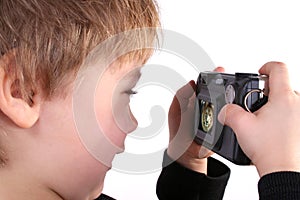 Young boy taking a photograph