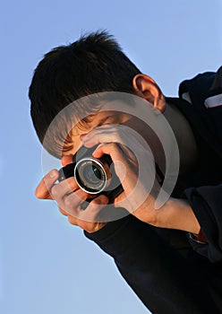 Young boy taking photos