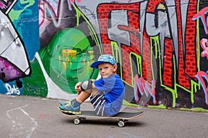 Young boy taking a rest at the skate park